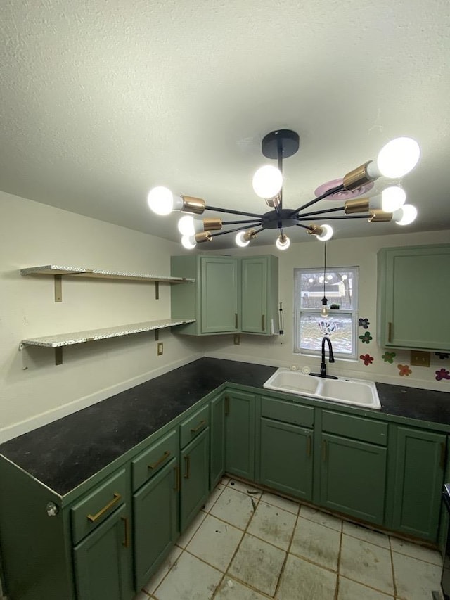 kitchen featuring green cabinetry, sink, and a textured ceiling