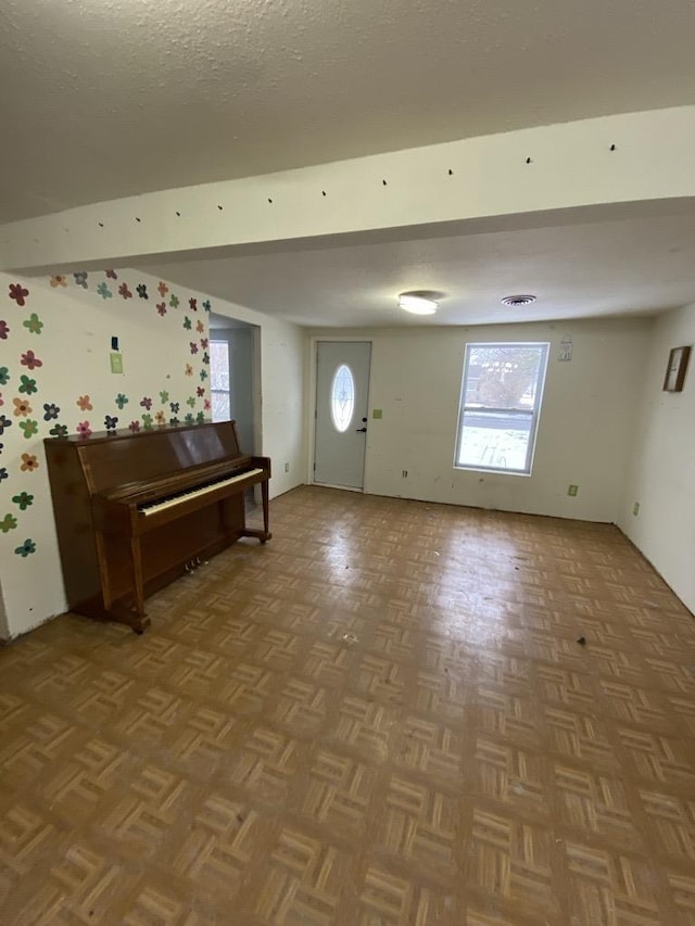 entrance foyer with parquet flooring and a textured ceiling