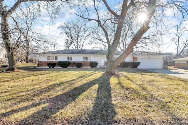 ranch-style home featuring brick siding, an attached garage, concrete driveway, and a front lawn