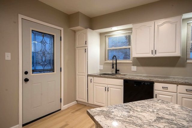 kitchen featuring white cabinetry, light hardwood / wood-style floors, dishwasher, and sink