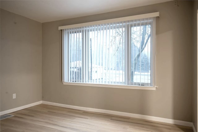 spare room with hardwood / wood-style flooring