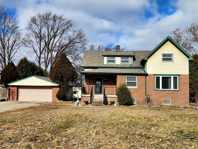 view of front of house featuring a garage, an outdoor structure, a front yard, and covered porch