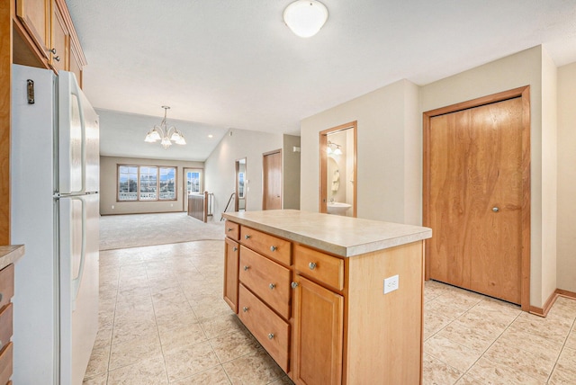 kitchen featuring pendant lighting, light tile patterned floors, an inviting chandelier, a center island, and white fridge