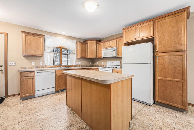 kitchen featuring a kitchen island, sink, light tile patterned floors, and white appliances