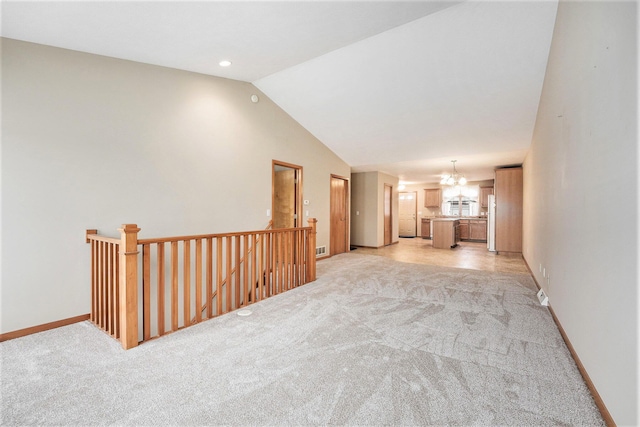 interior space with vaulted ceiling, light colored carpet, and a chandelier