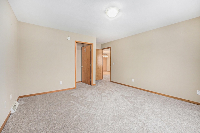 empty room featuring light carpet