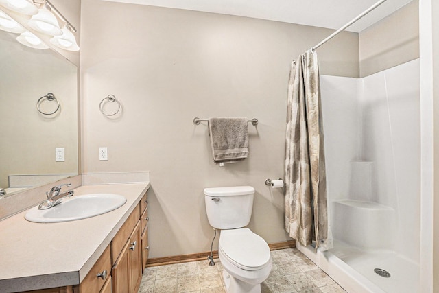 bathroom with vanity, toilet, and curtained shower