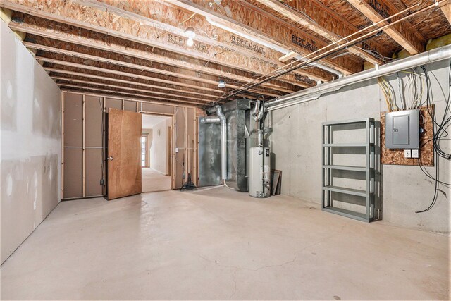 basement featuring gas water heater and electric panel