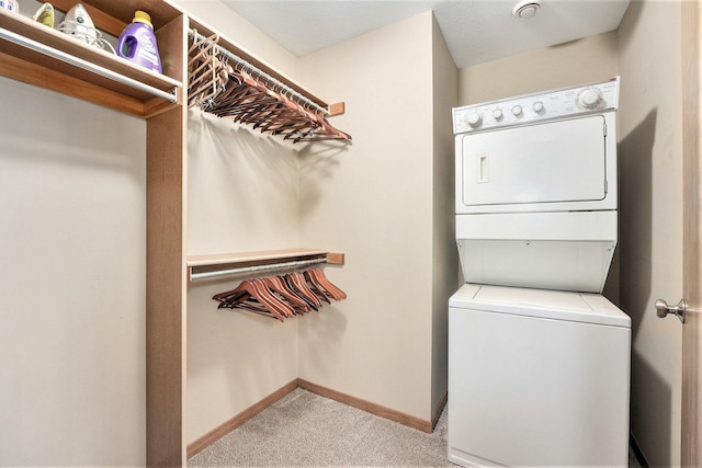 washroom featuring light colored carpet and stacked washing maching and dryer