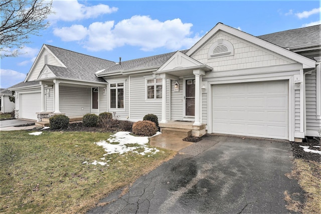 ranch-style house with a garage and a front lawn