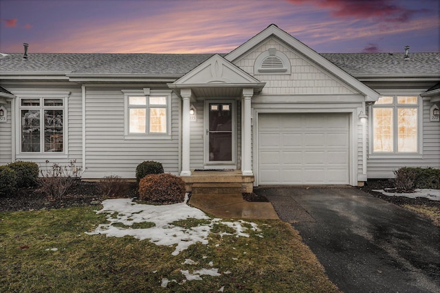 view of front of property with a yard and a garage