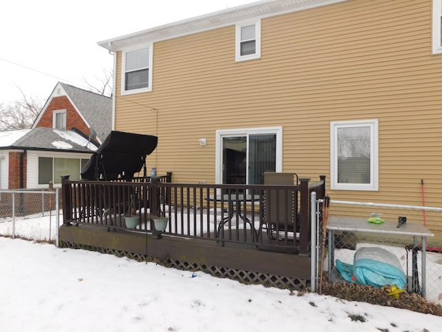 snow covered property with a deck