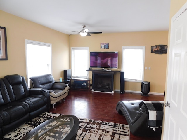 living room featuring ceiling fan, dark hardwood / wood-style floors, and a wealth of natural light