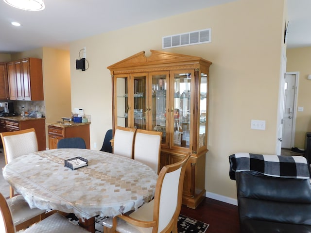 dining area featuring dark hardwood / wood-style floors