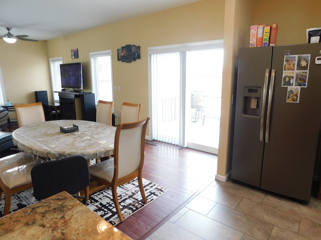 dining space with light tile patterned floors and ceiling fan