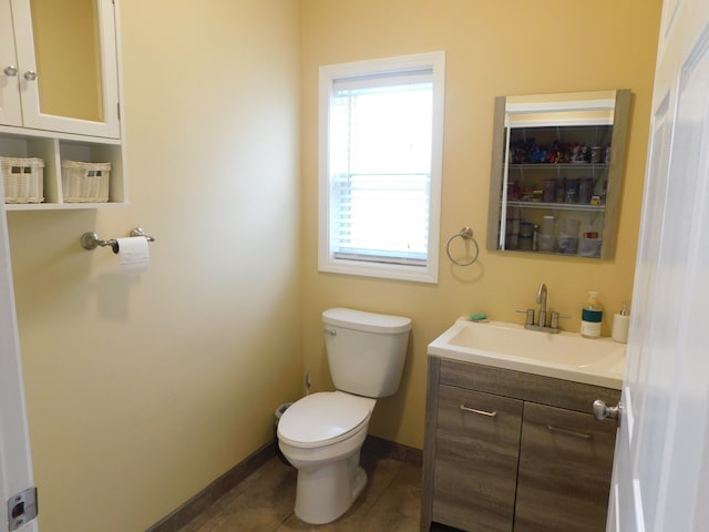 bathroom featuring tile patterned flooring, vanity, and toilet