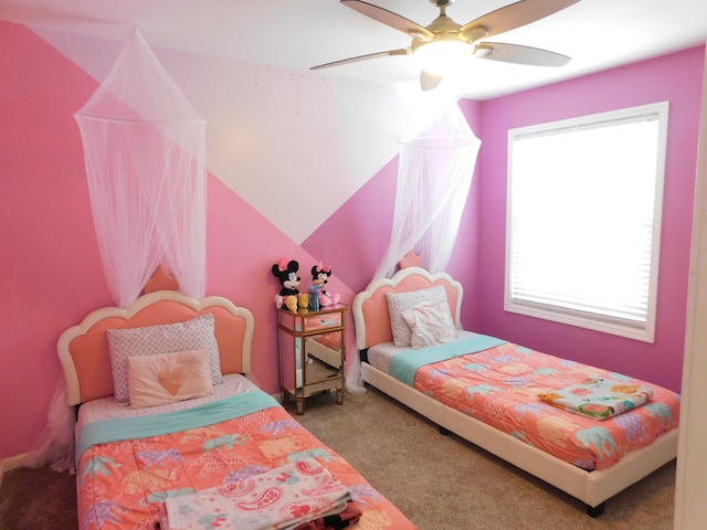 bedroom with ceiling fan, lofted ceiling, and carpet flooring