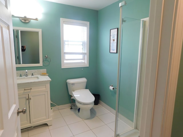 bathroom featuring tile patterned flooring, vanity, a shower with shower door, and toilet