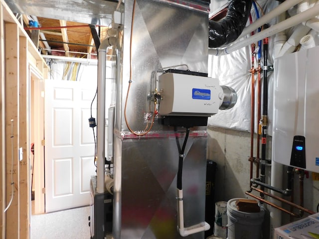 utility room featuring heating unit and tankless water heater