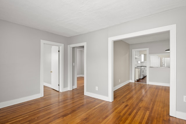 unfurnished room featuring a textured ceiling and dark hardwood / wood-style flooring