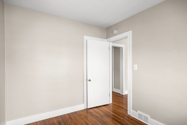 unfurnished room featuring dark hardwood / wood-style flooring