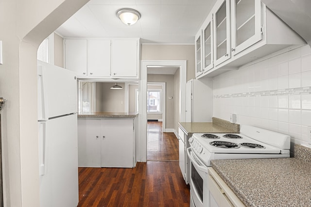 kitchen featuring white cabinetry, light stone countertops, dark hardwood / wood-style floors, and white appliances