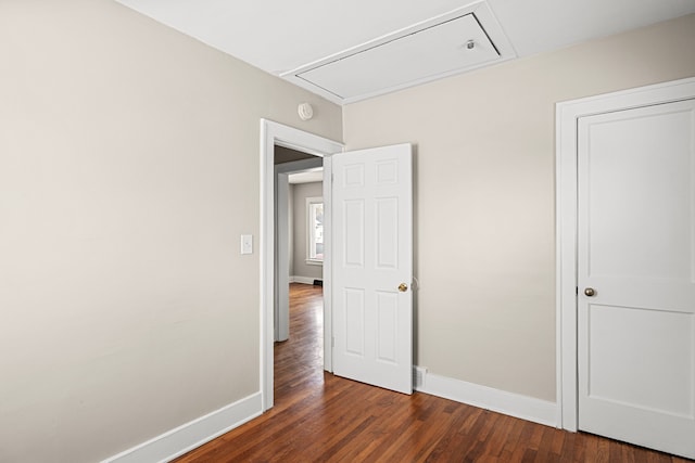 unfurnished bedroom with dark wood-type flooring