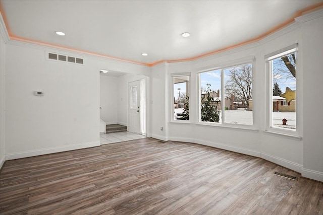 interior space featuring crown molding and light hardwood / wood-style floors