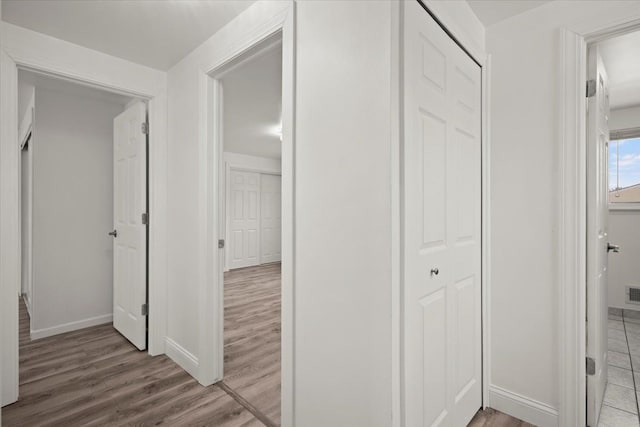 corridor with light hardwood / wood-style flooring