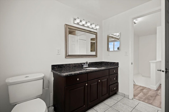 bathroom with vanity, tile patterned floors, and toilet