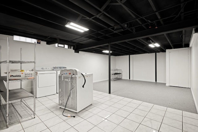 basement featuring light carpet and washer and clothes dryer