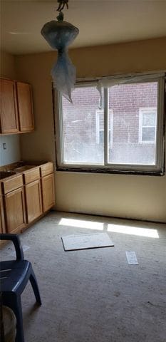 unfurnished dining area featuring light carpet