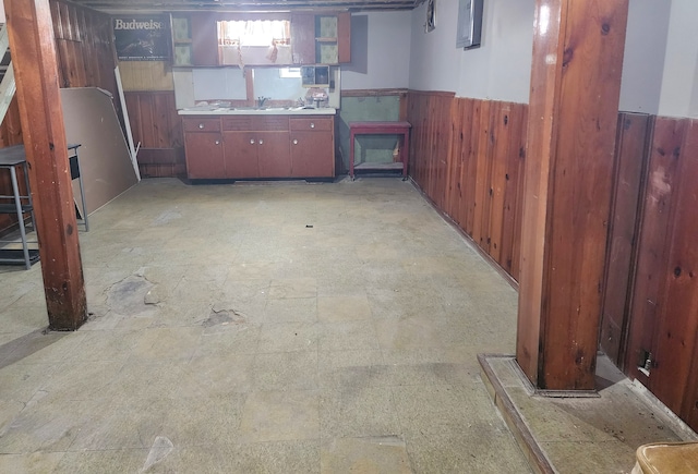 basement with sink and wooden walls