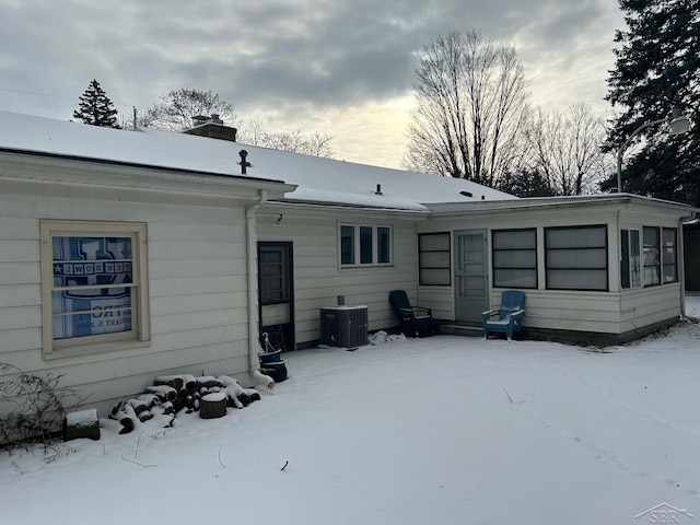 snow covered property with cooling unit