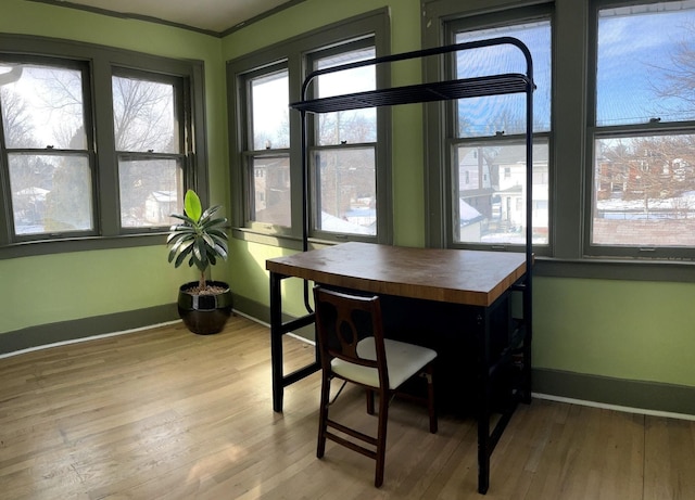 dining room featuring light hardwood / wood-style flooring and ornamental molding