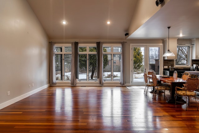 dining room featuring lofted ceiling and dark wood-type flooring