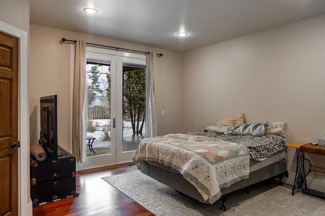 bedroom with wood-type flooring, access to exterior, and french doors