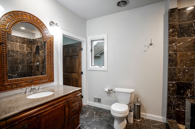 bathroom featuring vanity, toilet, and a shower