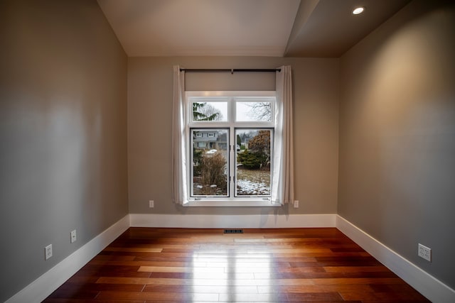 spare room with hardwood / wood-style flooring