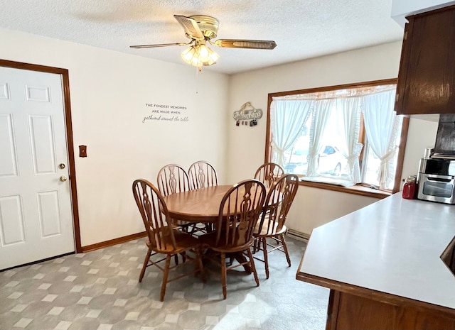 dining space featuring a textured ceiling and ceiling fan