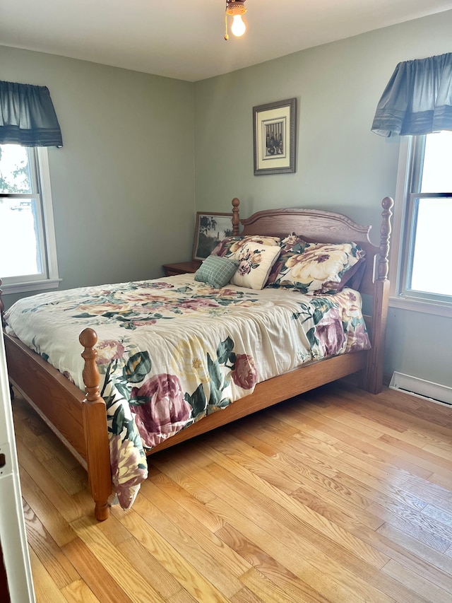 bedroom featuring multiple windows and light wood-type flooring