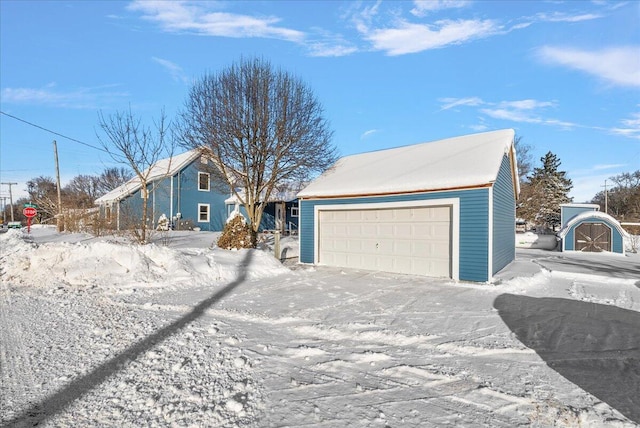 view of front of home with a garage and an outdoor structure