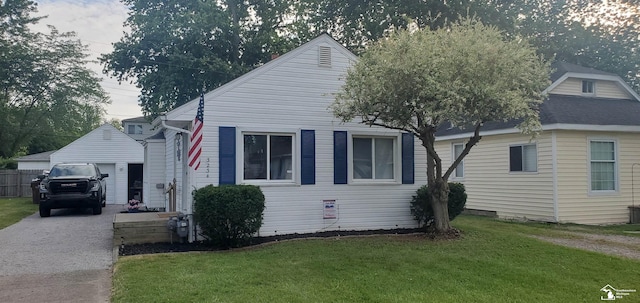 bungalow-style home featuring a garage and a front yard