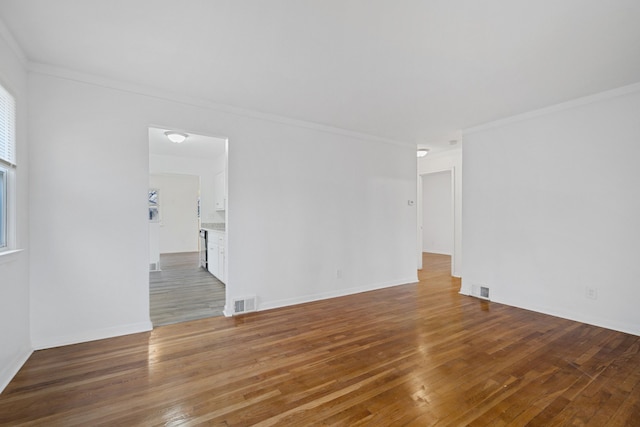 unfurnished room with crown molding and hardwood / wood-style flooring