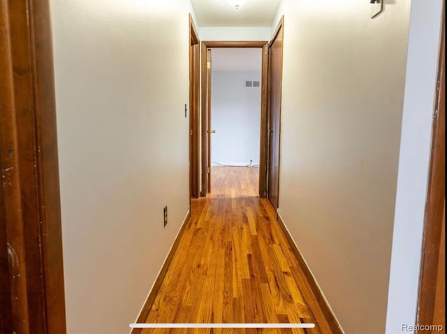 hallway featuring hardwood / wood-style flooring