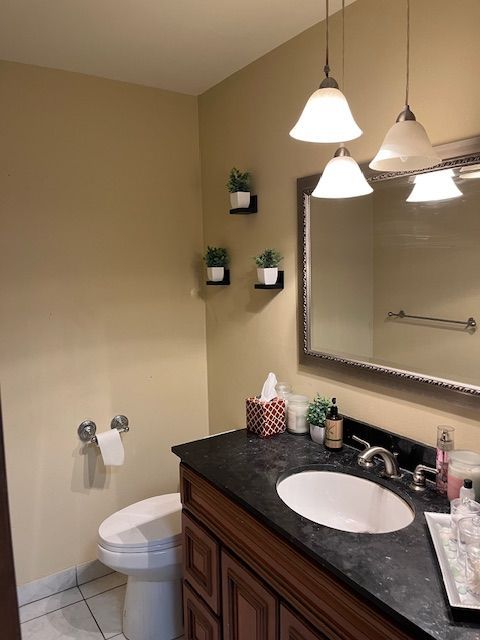 bathroom with vanity, tile patterned floors, and toilet