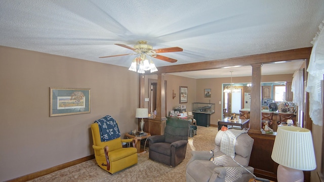 carpeted living room with ceiling fan, decorative columns, and a textured ceiling