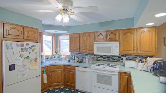 kitchen with tasteful backsplash, ceiling fan, sink, and white appliances