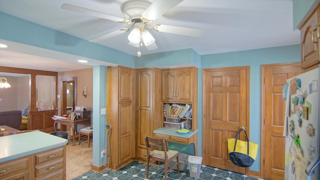 office space with ceiling fan with notable chandelier