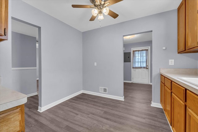 kitchen with ceiling fan and wood-type flooring